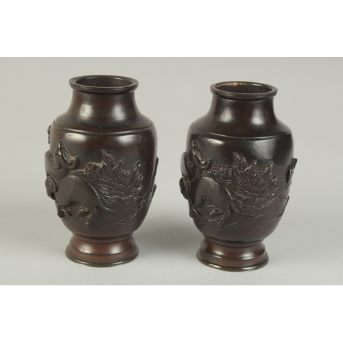 88 - A PAIR OF JAPANESE BRONZE VASES, relief decorated with rams and flora, 13.5cm high.