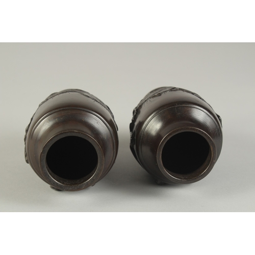 88 - A PAIR OF JAPANESE BRONZE VASES, relief decorated with rams and flora, 13.5cm high.