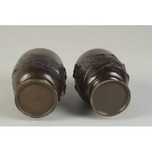 88 - A PAIR OF JAPANESE BRONZE VASES, relief decorated with rams and flora, 13.5cm high.