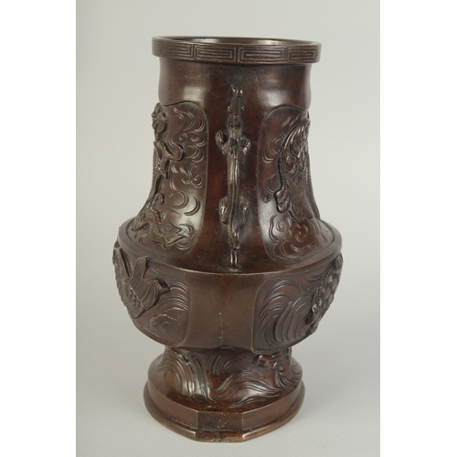 89 - AN UNUSUAL BRONZE TWIN HANDLE DRAGON AND PHOENIX VASE, with panels of relief decoration including a ... 
