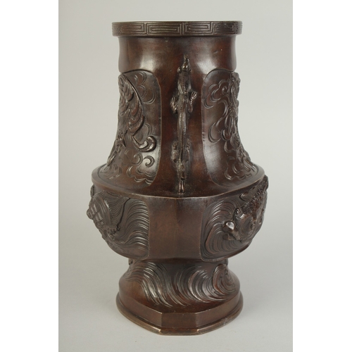 89 - AN UNUSUAL BRONZE TWIN HANDLE DRAGON AND PHOENIX VASE, with panels of relief decoration including a ... 