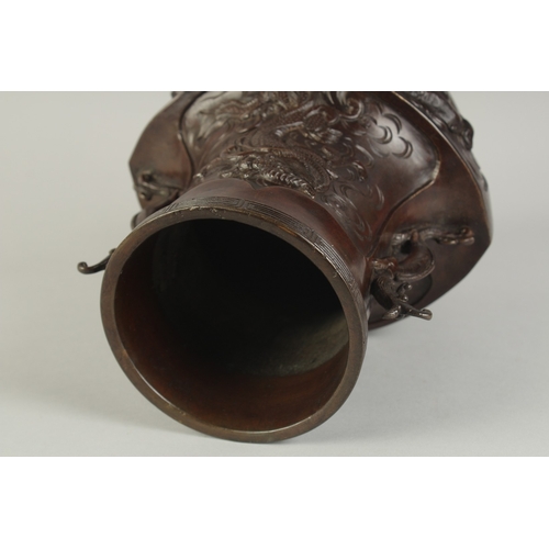 89 - AN UNUSUAL BRONZE TWIN HANDLE DRAGON AND PHOENIX VASE, with panels of relief decoration including a ... 
