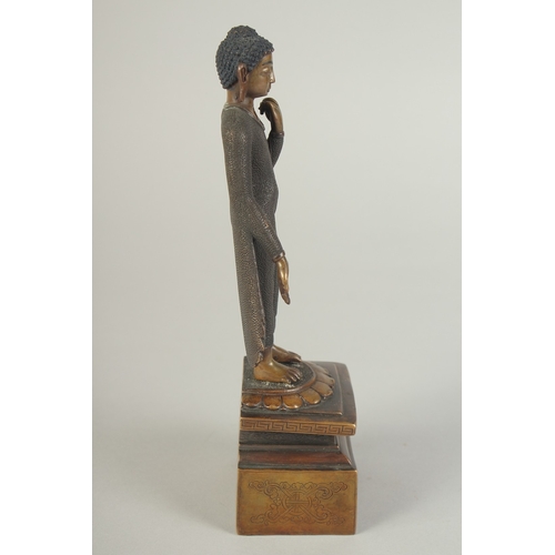 90 - A FINELY FETTLED BRONZE STANDING BUDDHA, fitted to a lotus base plinth, 21cm high.
