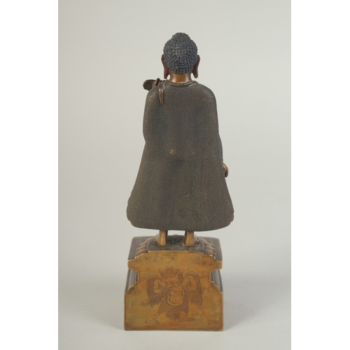 90 - A FINELY FETTLED BRONZE STANDING BUDDHA, fitted to a lotus base plinth, 21cm high.