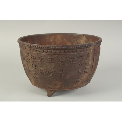 94 - AN EARLY MING CAST IRON CENSER, with script and lotus decoration, raised on three feet, 29cm diamete... 