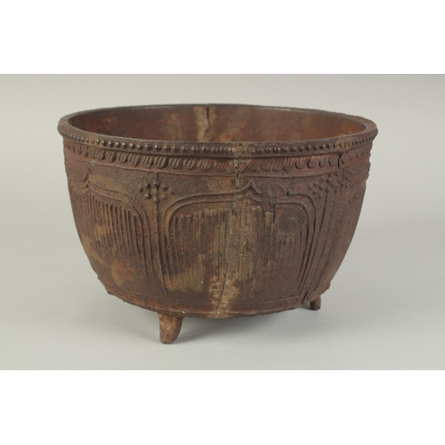94 - AN EARLY MING CAST IRON CENSER, with script and lotus decoration, raised on three feet, 29cm diamete... 