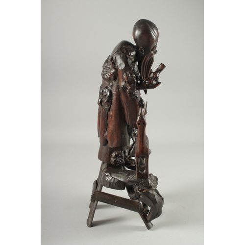 95 - A CHINESE SECTIONAL ROOT WOOD CARVING OF SHOU LAO, 41cm high overall.