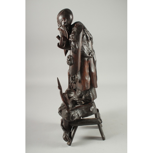 95 - A CHINESE SECTIONAL ROOT WOOD CARVING OF SHOU LAO, 41cm high overall.