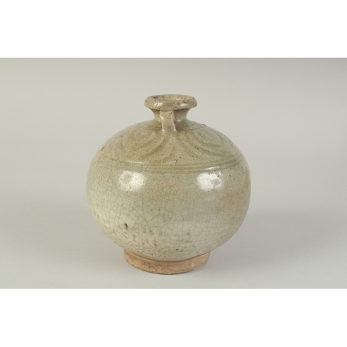 97 - A CHINESE CELADON GLAZED POTTERY TWIN HANDLE VESSEL, with carved decoration to the shoulder, 15cm hi... 