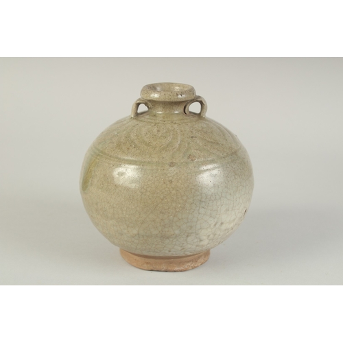 97 - A CHINESE CELADON GLAZED POTTERY TWIN HANDLE VESSEL, with carved decoration to the shoulder, 15cm hi... 