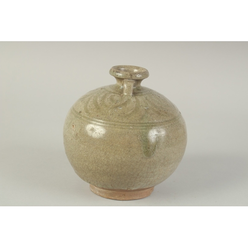 97 - A CHINESE CELADON GLAZED POTTERY TWIN HANDLE VESSEL, with carved decoration to the shoulder, 15cm hi... 