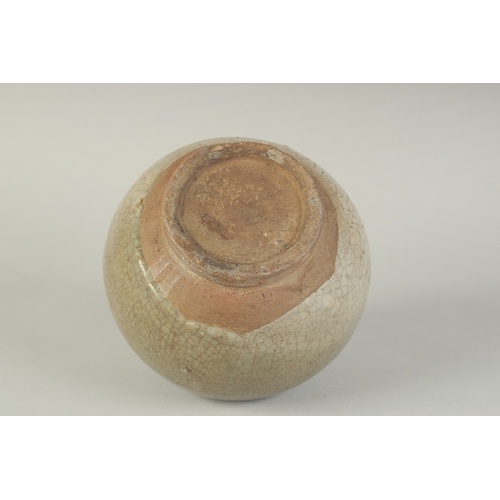 97 - A CHINESE CELADON GLAZED POTTERY TWIN HANDLE VESSEL, with carved decoration to the shoulder, 15cm hi... 