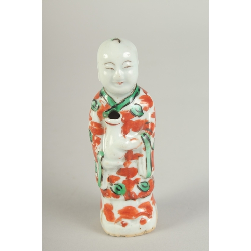 99 - A SMALL 19TH CENTURY PORCELAIN STANDING FIGURE, 11cm high.