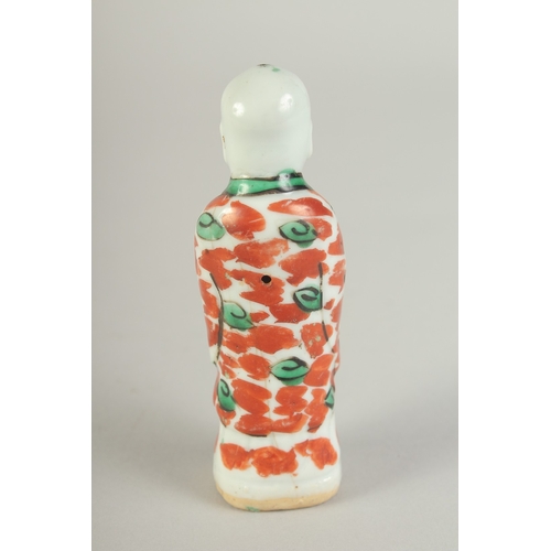 99 - A SMALL 19TH CENTURY PORCELAIN STANDING FIGURE, 11cm high.