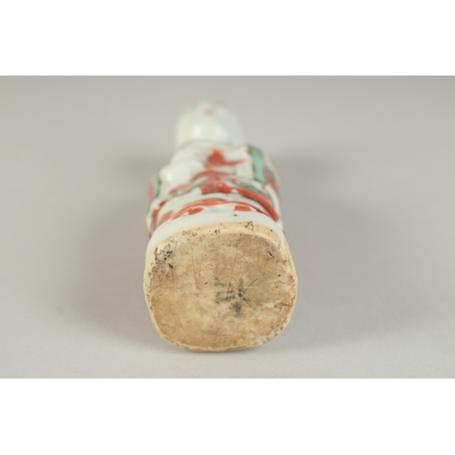 99 - A SMALL 19TH CENTURY PORCELAIN STANDING FIGURE, 11cm high.