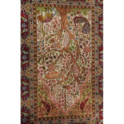 1003 - A SMALL PERSIAN PART SILK RUG cream ground with red ground border, 