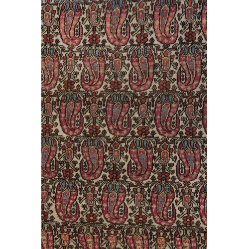 1006 - A GOOD PERSIAN RUG cream ground with stylised Boteh design. 6ft 5ins x 4ft 8ins.