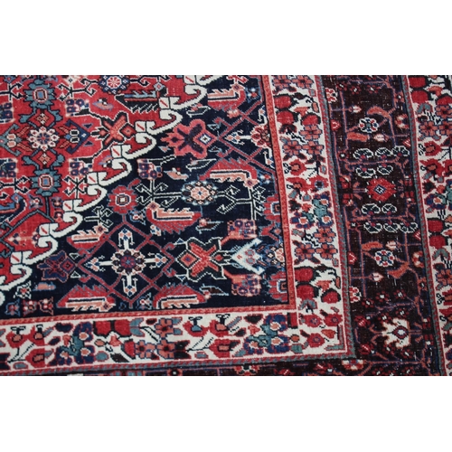 1008 - A GOOD PERSIAN CARPET red ground with all over stylised decoraction. 8ft 8ins x 5ft 4ins.