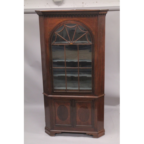 1015 - A GOOD GEORGE III MAHOGANY STANDING CORNER CUPBOARD the top with glass door enclosing two shaped she... 