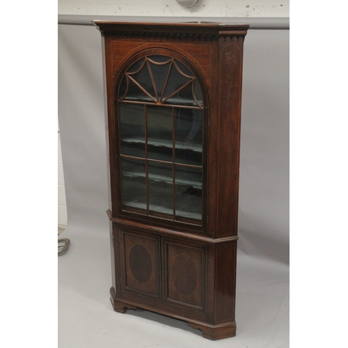 1015 - A GOOD GEORGE III MAHOGANY STANDING CORNER CUPBOARD the top with glass door enclosing two shaped she... 