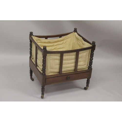 1019 - A GEORGIAN MAHOGANY CANTERBURY with turned supports, slatted sides and single drawer supported on br... 