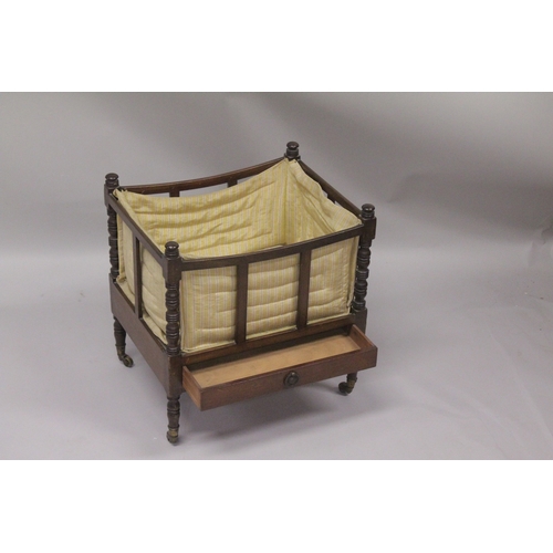 1019 - A GEORGIAN MAHOGANY CANTERBURY with turned supports, slatted sides and single drawer supported on br... 