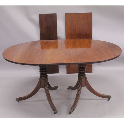 1023 - A GEORGIAN MAHOGANY 'D' END DOUBLE PILLAR DINING TABLE with two loose leaves, plain top, reeded edge... 