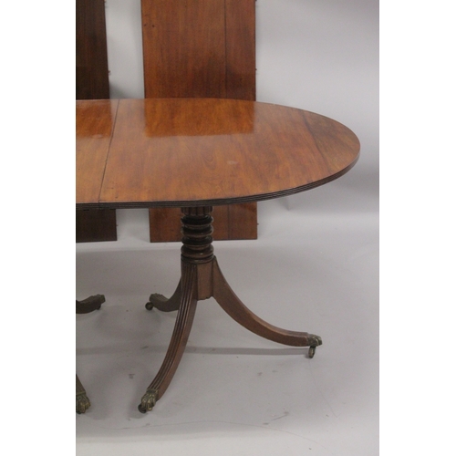 1023 - A GEORGIAN MAHOGANY 'D' END DOUBLE PILLAR DINING TABLE with two loose leaves, plain top, reeded edge... 