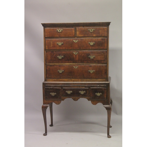 1024 - AN 18TH CENTURY OAK AND WALNUT CHEST ON STAND the top with two short and three long graduated drawer... 