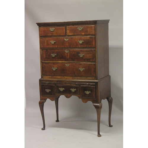 1024 - AN 18TH CENTURY OAK AND WALNUT CHEST ON STAND the top with two short and three long graduated drawer... 