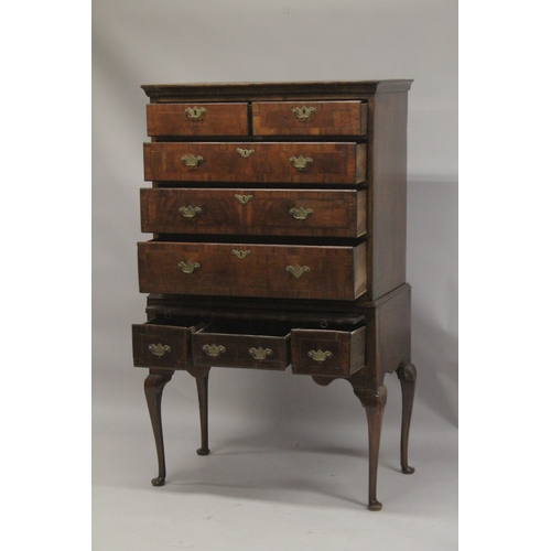 1024 - AN 18TH CENTURY OAK AND WALNUT CHEST ON STAND the top with two short and three long graduated drawer... 