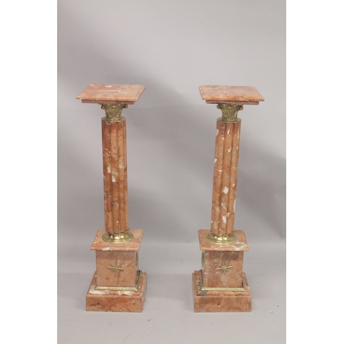 1039 - A GOOD PAIR OF PINK MARBLE CLUSTER COLUMNS with square tops and pedestal bases. 3ft 4ins high.