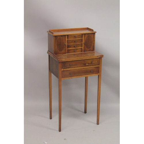 1053 - A SMALL YEW WOOD DESK the top with three drawers and a pair of panel doors, fold over flap over two ... 