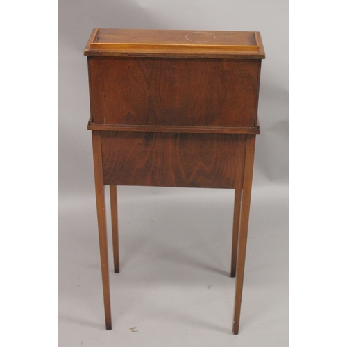 1053 - A SMALL YEW WOOD DESK the top with three drawers and a pair of panel doors, fold over flap over two ... 