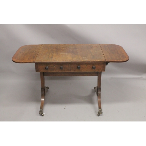 1055 - A REGENCY ROSEWOOD SOFA TABLE with folding flaps, on curving legs with casters. 4ft 4ins long flaps ... 