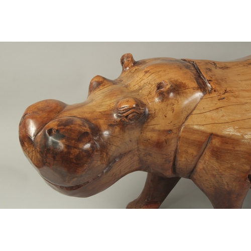 1062 - A LARGE HEAVY CARVED WOOD HIPPOPOTAMUS. 3ft long, 1ft 4ins high.