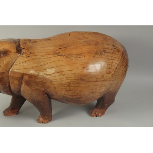 1062 - A LARGE HEAVY CARVED WOOD HIPPOPOTAMUS. 3ft long, 1ft 4ins high.