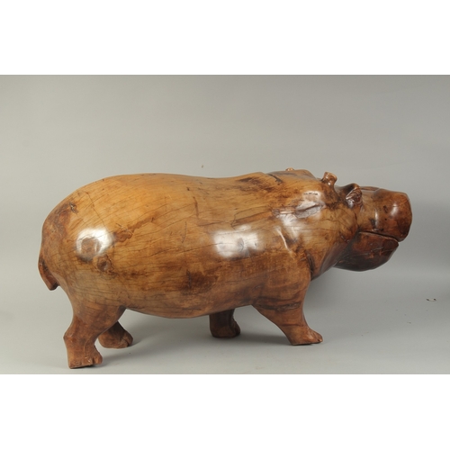 1062 - A LARGE HEAVY CARVED WOOD HIPPOPOTAMUS. 3ft long, 1ft 4ins high.