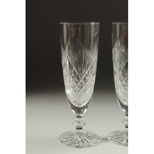 1080 - A PAIR OF CUT GLASS WINE FLUTES.