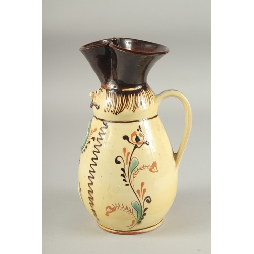 1106 - A HUNGARIAN ART POTTERY MISKO WINE JUG with a man's  face and snake. Signed.  9ins high.