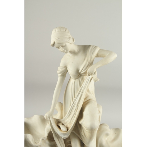 1114 - A WHITE BISQUE SHELL GROUP, a young girl with a fish, on a circular base. 1ft 5ins high.