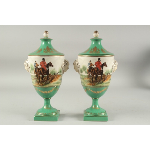 1118 - A PAIR OF SEVRES DESIGN PORCELAIN URN SHAPED VASES AND COVERS decorated with hunting scenes. 12ins h... 