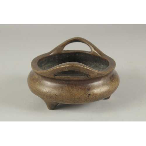 1154 - A CHINESE BRONZE CIRCULAR TWO HANDLED CENSER. 4.75ins diameter.