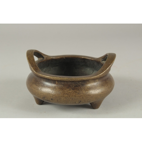 1154 - A CHINESE BRONZE CIRCULAR TWO HANDLED CENSER. 4.75ins diameter.