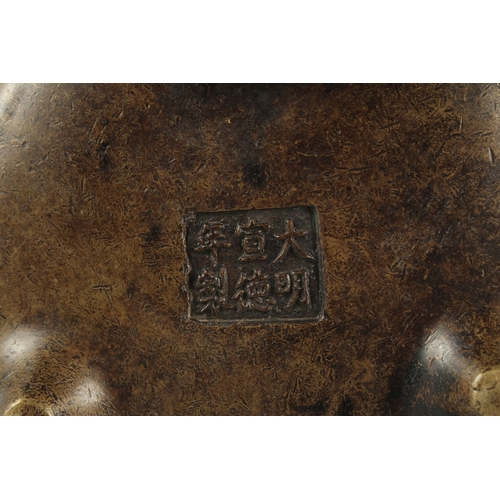 1154 - A CHINESE BRONZE CIRCULAR TWO HANDLED CENSER. 4.75ins diameter.