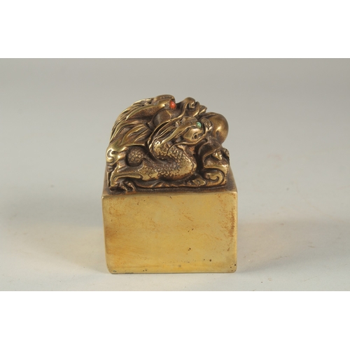 1158 - A CHINESE BRONZE SQUARE SEAL with dragons. 2.75ins .