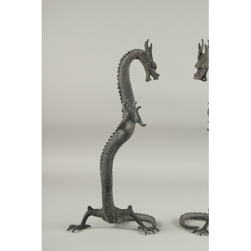 1161 - A PAIR OF CHINESE BRONZE DRAGONS. 1ft 4ins high.