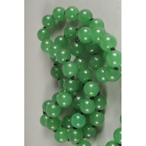 1182 - A STRING OF JADE BEADS.  24ins long.