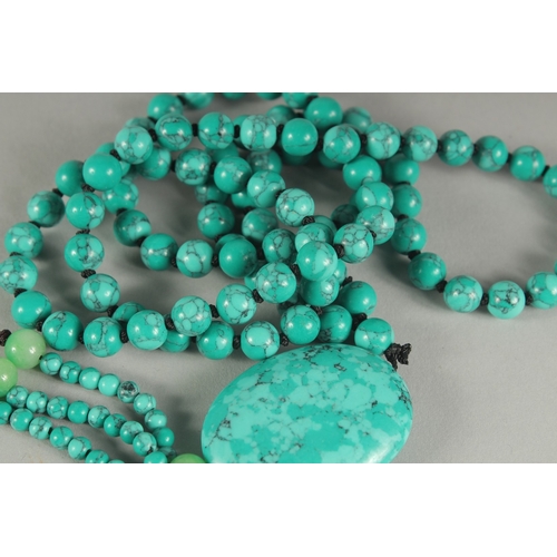 1183 - A STRING OF ONE HUNDRED TURQUOISE BEADS AND PENDANT. 20ins long overall.