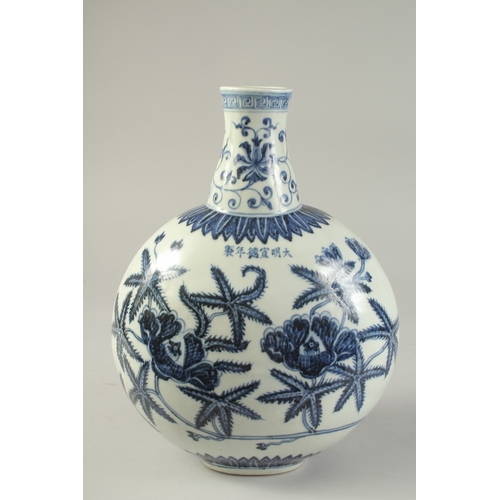 1186 - A  CHINESE BLUE AND WHITE PORCELAIN  MOON FLASK with floral decoration.  31cm high.